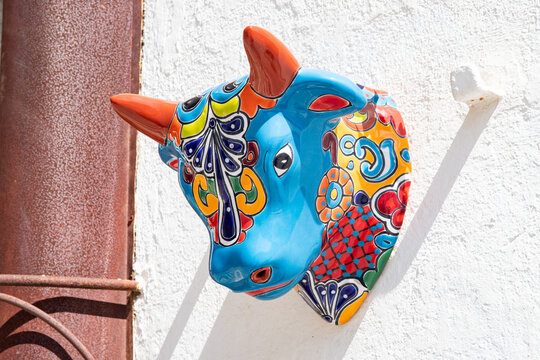 ceramic bull head in mexican talavera style on white wall