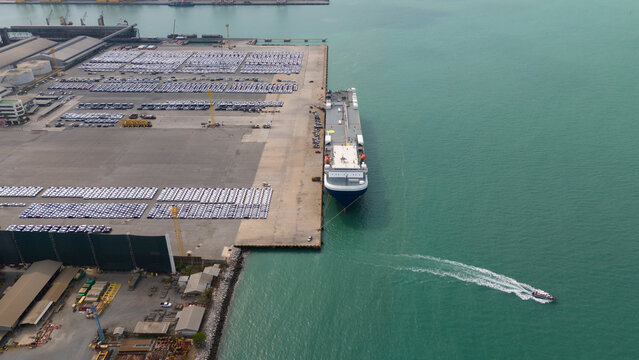 aerial view of new cars parked at the parking area of automobile factory, waiting for RORO transport of international	