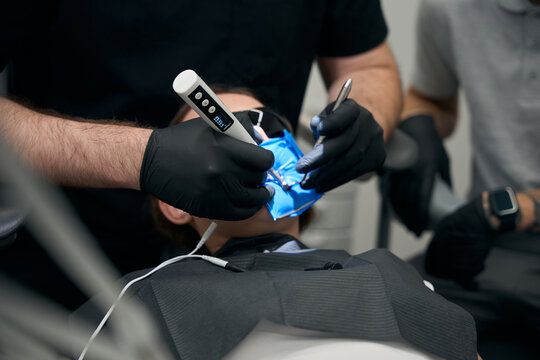 Person receiving dental treatment in clinical office