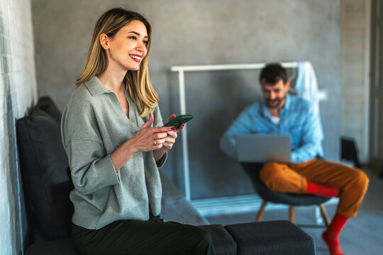 Couple balancing remote work and digital communication at home, reflecting freelancing, productivity