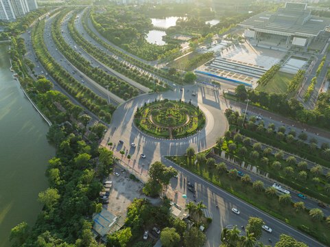 Aerial perspective of landscaped roundabout and tree lined boulevard near Thang Long Boulevard in western Hanoi during early morning.