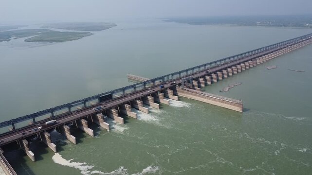 panoramic drone shot video clip of long national highway river bridge with moving vehicles on a bright sunny day in India