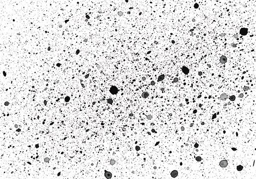 Microscopic view of scattered dark particles on a light background surface