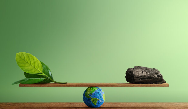 Balance scale with green leaf and coal, Carbon emission balance, environmental sustainability and climate change