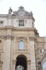 Fototapeta premium Historic Cathedral Facade with Ornate Clock Tower and Classical Sculptures