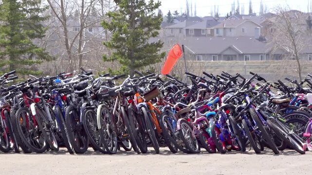 A massive row of discarded bicycles sits at a Landfill for recycling or waste management.
