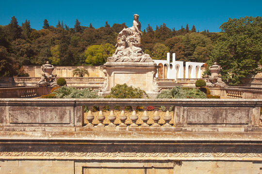 Hidden gems of France concept. A scenic view  of The Nymph Nemausa monument in Jardins de la Fontaine, Nimes. Outdoor shot. Sunny weather.
