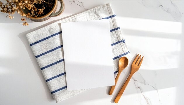 White Paper on Striped Napkin with Wooden Utensils and Dried Flowers