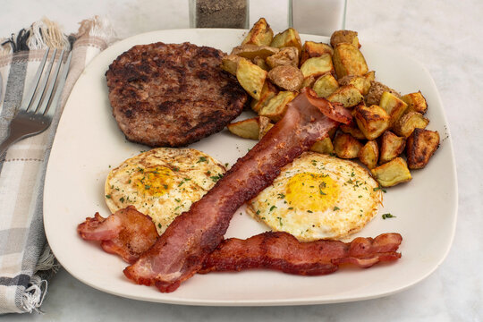 eggs over easy with bacon and  home fries