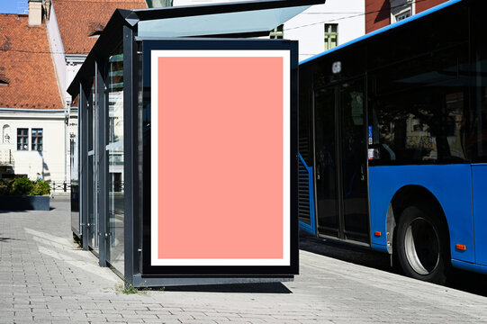 blank poster sign panel bus shelter. billboard mockup display. white lightbox sign in bus stop. digital panel. city transit station. urban street. park setting. outdoor advertising