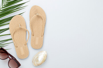 Flip flops with summer accessories on color background, top view © Liami