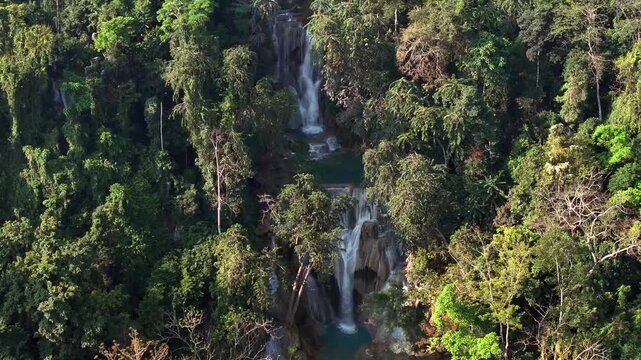 Aerial view of a Beautiful Kuang Si Waterfall in Luang Prabang, Laos. Top View Drone Shot of Lush Jungle in Lao.