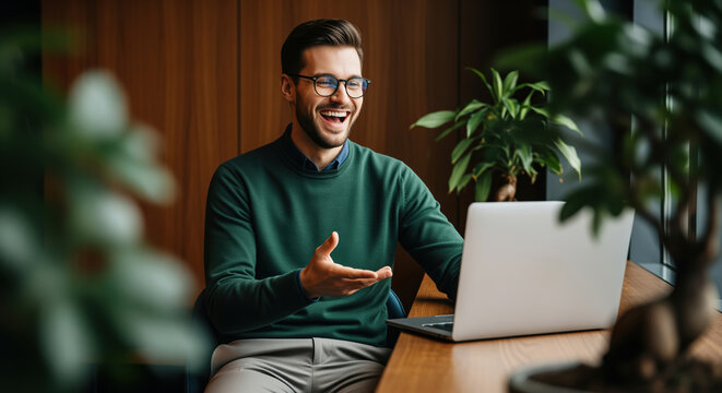 Video call consultation scene for remote coaching, online interview and virtual meeting use, showing a smiling man at a computer during a friendly call in an office setting for work service visuals