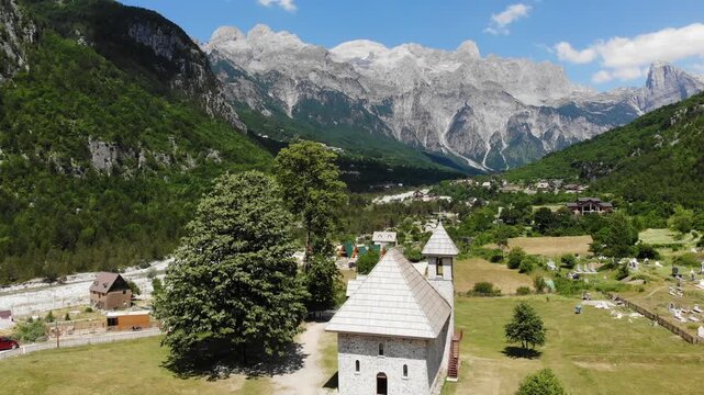 Theth village church. Summer landscape of Theth Mountains in Albanian Alps (also known as Accursed Mountains). Alps of Albania National Park.