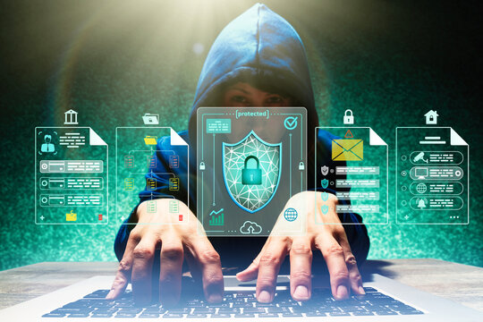 Person in a hoodie typing on laptop with virtual security interface and shield icon, representing cybersecurity, hacking threat, data protection and privacy.