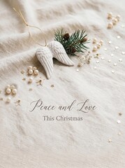 Obraz premium Minimal neutral christmas greeting card front with angel wings ornament and pine sprig for holiday card design