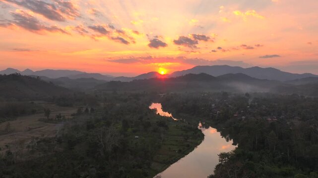 Beautiful Sunset in Nong Khiaw, a drone shot of picturesque Mountain Town on the Nam Ou River in Laos, Southeast Asia