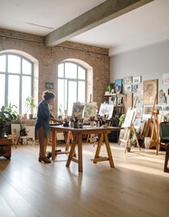Fototapeta premium A woman in a bright art studio, surrounded by easels and artwork. Sunlight streams into the large room with high ceilings and exposed brick walls. A wooden table holds art supplies