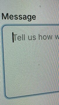 4K vertical macro view of a blinking cursor in a message box with the placeholder text "Tell us how w..." on a dark mode screen.