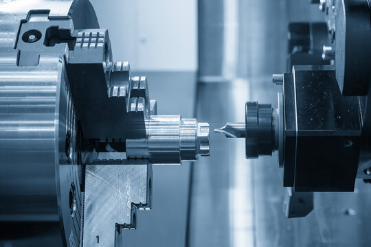 High-precision hole guide drilling using a center drill tool on a metal shaft part with a CNC lathe machine.