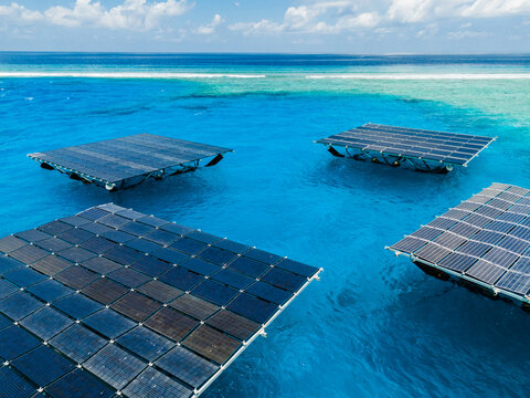 Aerial view of SolarSea floating solar power plant by Swimsol on turquoise waters near a coral reef in Dharavandhoo, Baa Atoll, Maldives.