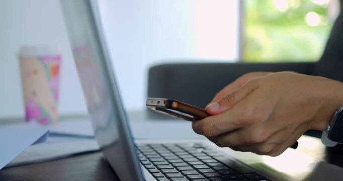 Shopping device comparison. Casual individual inspecting product information on multiple screens. Person leisurely comparing specifications of phone and laptop on various digital displays