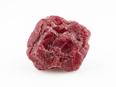Isolated rough red ruby stone with jagged edges and crystalline texture mineral