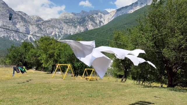 Outdoor drying fresh laundry. White towels on a clothesline in Theth, Albania.
