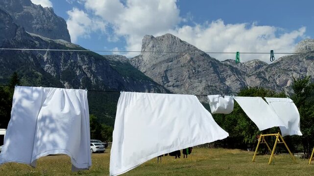 Outdoor drying fresh laundry. White towels on a clothesline in Theth, Albania.