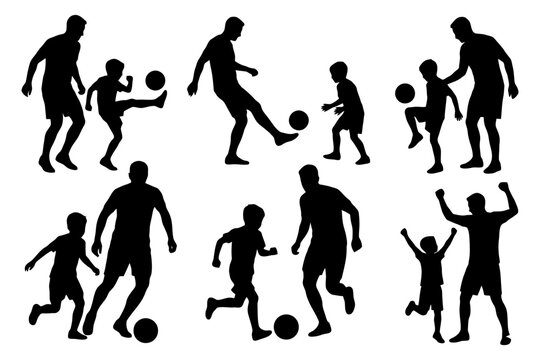 Father and son silhouettes playing soccer.