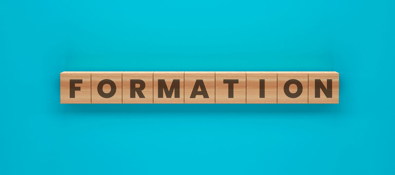 Formation of Wooden Tiles: Wooden tiles spelling out FORMATION against a vibrant blue background, creating a visual representation of structure and organization.