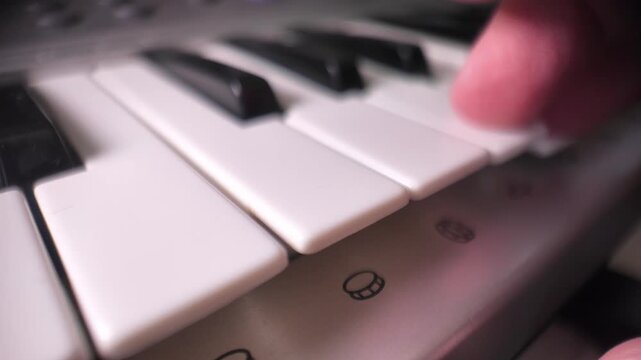 Fingers playing piano keys slow motion close up musician performing keyboard music instrument artistic performance concept