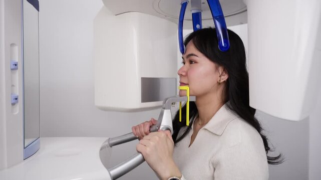 Asian woman taking dental x ray scan