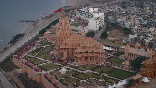 Aerial view of Somnath Temple in Gujarat, India, showcasing the grand coastal shrine dedicated to Lord Shiva. The image highlights the temple&rsquo;s majestic architecture and the Arabian Sea.