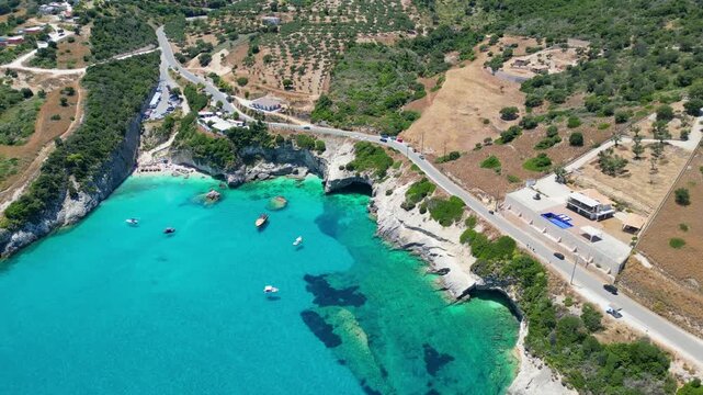 Spectacular drone view of Xigia Sulfur Beach in Zakynthos. Famous for its healing sulfur springs, crystal turquoise water, and steep limestone cliffs in a scenic Greek island bay.