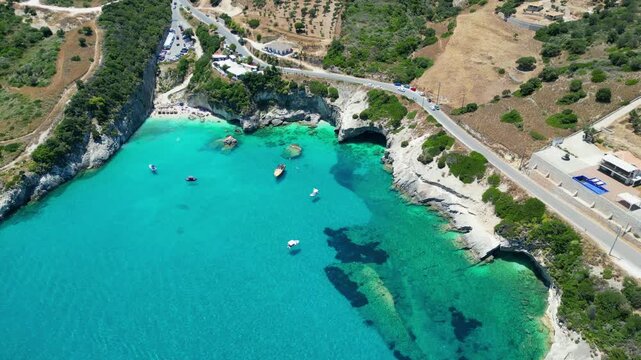 Spectacular drone view of Xigia Sulfur Beach in Zakynthos. Famous for its healing sulfur springs, crystal turquoise water, and steep limestone cliffs in a scenic Greek island bay.