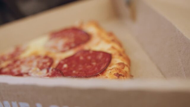 Empty pizza box showing grease stains, scattered crumbs after takeaway meal, latenight office snack, party leftover closeup textured cardboard interior with oil marks and moody lighting