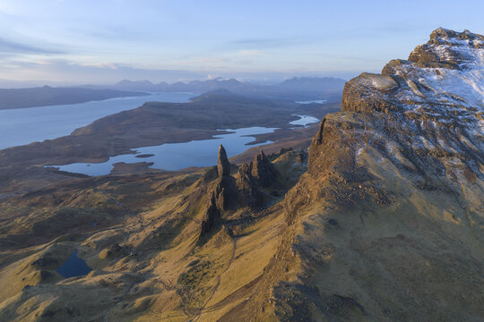 Aerial view of The Storr rock formation with its iconic pinnacles and snowy ridges overlooking Loch Leathan Isle of Skye, Scotland, United Kingdom.