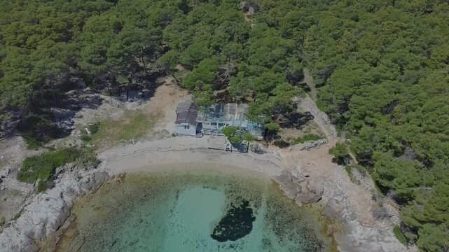 Aerial drone view of Mediterranean coast with pine forest,sand and clear sea