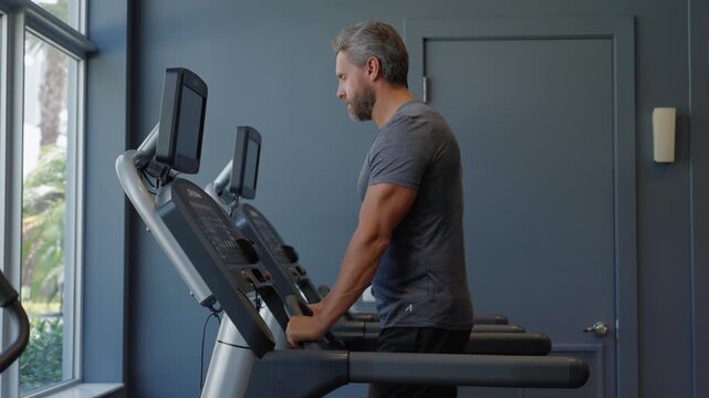 Miami, Florida, USA - April 16, 2025: Sportsman running on treadmill in gym. Treadmill workout in fitness gym. Exercises on cardio. Sportsman running on treadmill in fitness gym. Sport man recreation