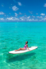  Paradise beaches of the Maldives. Tourism, travel and vacation in a luxury resort. Woman in bikini on the background of the sea and the beach