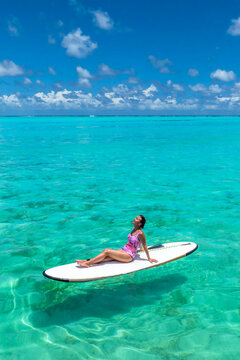  Paradise beaches of the Maldives. Tourism, travel and vacation in a luxury resort. Woman in bikini on the background of the sea and the beach