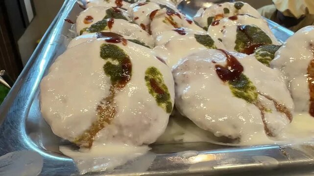 Close up shot of Dahi vada garnished with red and green chutney in India