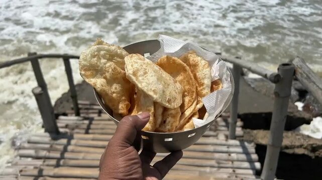 Dal puri and chana served with sea waves in the background; professional travel and food photography of traditional Indian beachside street food, coastal holiday snacks, and scenic ocean dining.