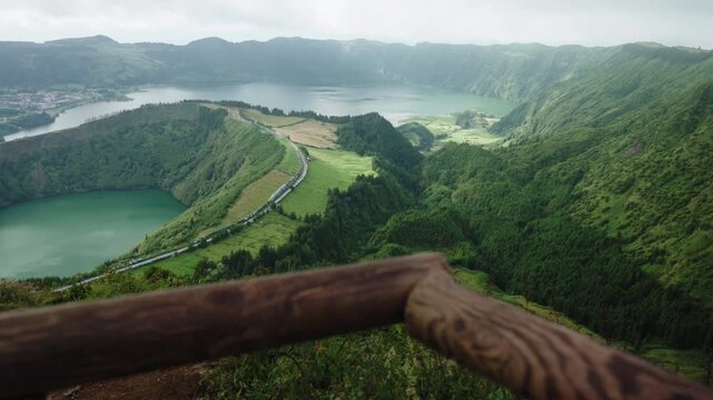 Cinematic High-Angle Vista of the Sete Cidades Volcanic Crater and Twin Lakes from a Wooden Viewpoint, Azores