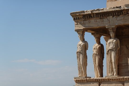 Two of the famous architectural columns known as Caryatids, located on the south porch of the Erechtheion temple on the Acropolis of Athens, Greece, carved in the form of draped female figures