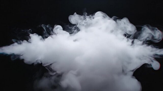 Large white smoke cloud rises rapidly in dark environment