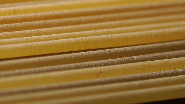 Spaghetti pasta slowly sliding, close-up, texture, macro.