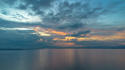 Fototapeta premium Dramatic Sunset Over Calm Ocean Waters