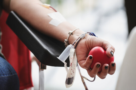 Blood donor hand detail during blood donation procedure